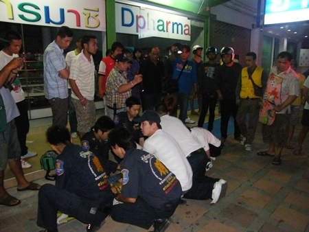 Rescue workers try to save the life of one of the gang members.